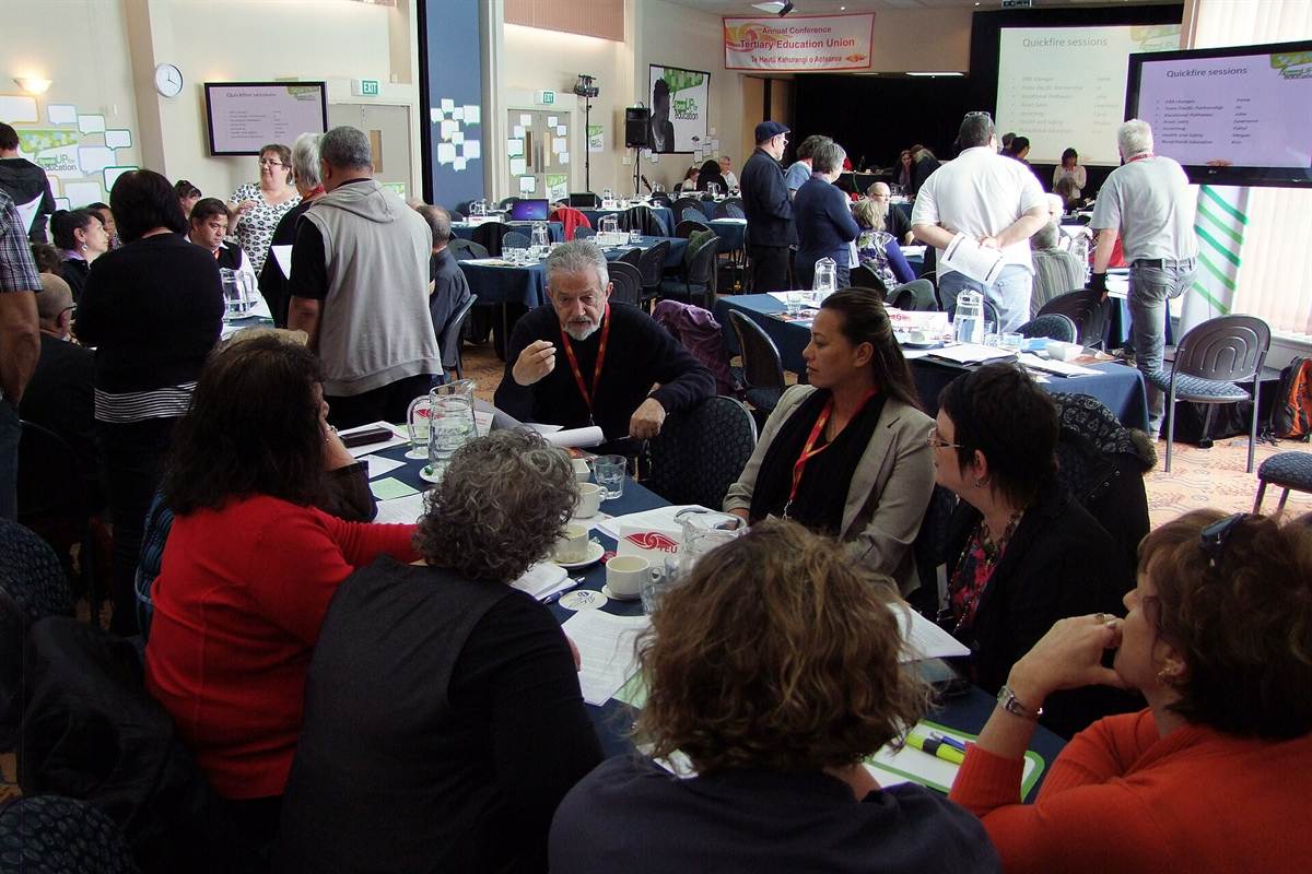 Adult education workshop: participants in discussion around working tables, documents in hand